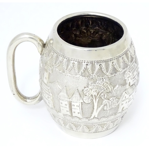 350 - A white metal mug with loop handle, decorated with Colonial British West Indies style landscape scen... 