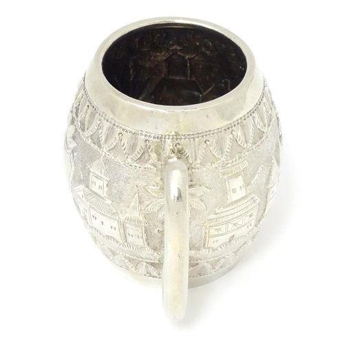 350 - A white metal mug with loop handle, decorated with Colonial British West Indies style landscape scen... 