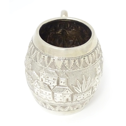 350 - A white metal mug with loop handle, decorated with Colonial British West Indies style landscape scen... 