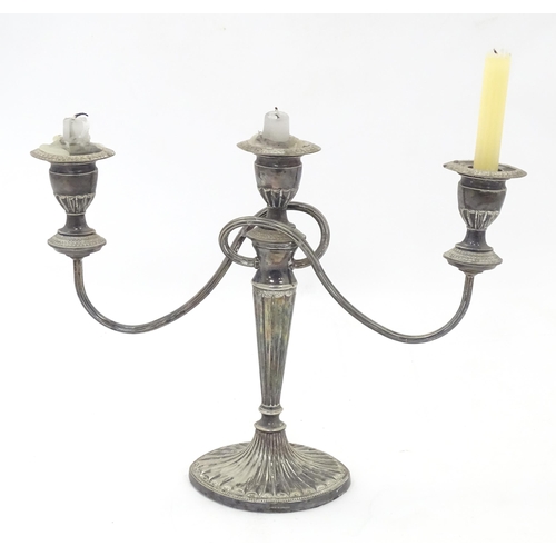 546 - Assorted silver plated wares to include a three branch candelabra, a cut glass twin handled biscuit ... 