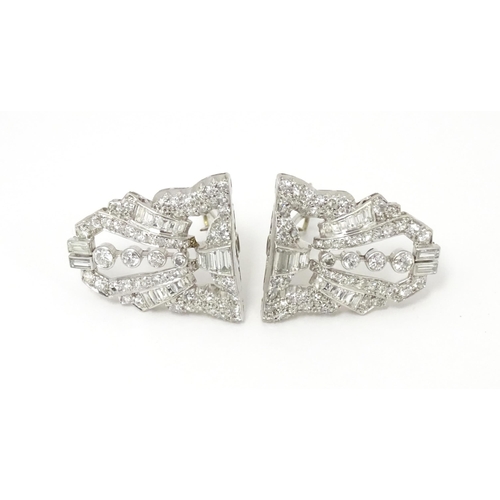 768 - A pair of Art Deco white metal collar clips set with a profusion of diamonds. Each approx. 1