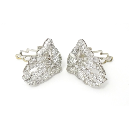 768 - A pair of Art Deco white metal collar clips set with a profusion of diamonds. Each approx. 1