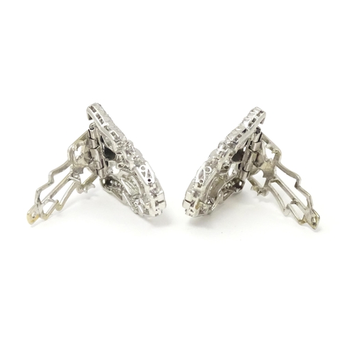 768 - A pair of Art Deco white metal collar clips set with a profusion of diamonds. Each approx. 1