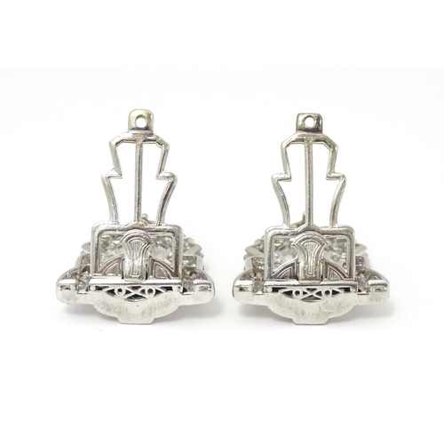 768 - A pair of Art Deco white metal collar clips set with a profusion of diamonds. Each approx. 1