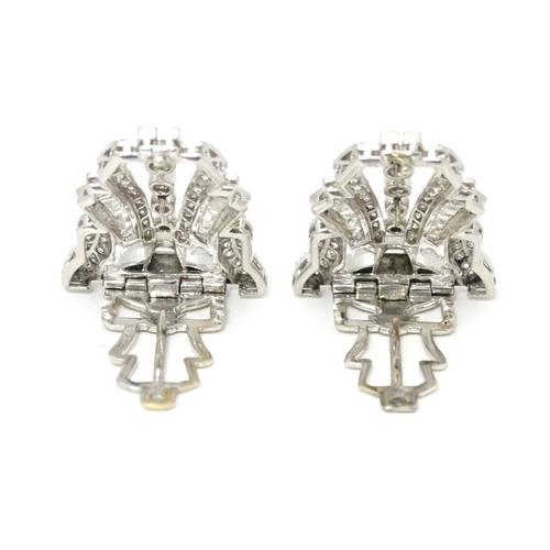 768 - A pair of Art Deco white metal collar clips set with a profusion of diamonds. Each approx. 1