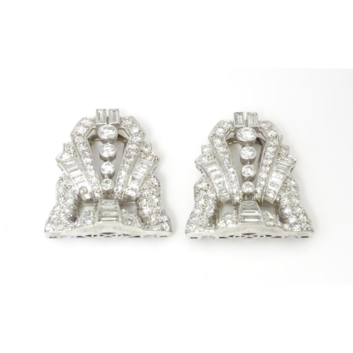 768 - A pair of Art Deco white metal collar clips set with a profusion of diamonds. Each approx. 1