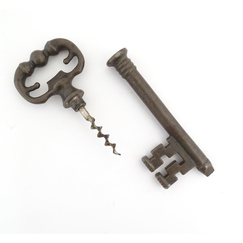 1063 - A 20thC novelty corkscrew / bottle opener modelled as an old key, titled The Key to Happiness. In or... 