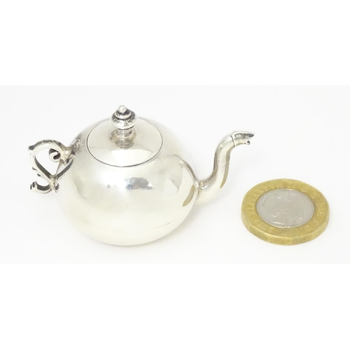 302 - A .925 silver miniature model of a teapot. Approx. 2 1/4