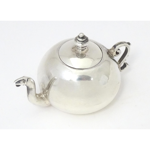 302 - A .925 silver miniature model of a teapot. Approx. 2 1/4