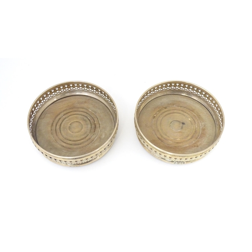 385 - A pair of silver bottle coasters with turned wooden bases, hallmarked London 1968. Approx. 5 1/4