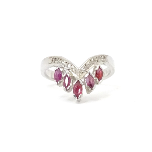 555 - A silver ring set with red and white stones. Ring size approx. M 1/2