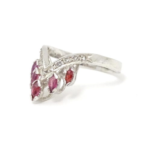 555 - A silver ring set with red and white stones. Ring size approx. M 1/2