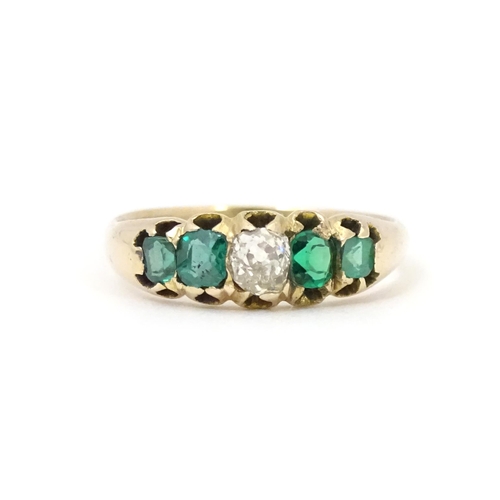 619 - An 18ct gold ring set with central diamond flanked by two emeralds. Together with insurance valuatio... 