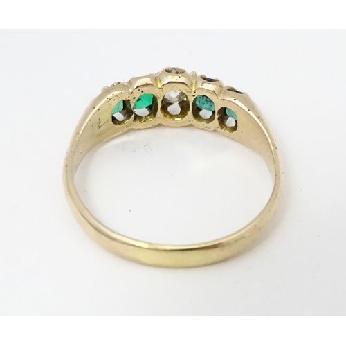 619 - An 18ct gold ring set with central diamond flanked by two emeralds. Together with insurance valuatio... 