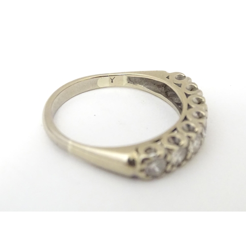 622 - An 18ct white gold half eternity ring set with seven diamonds in a linear setting. Ring size approx.... 