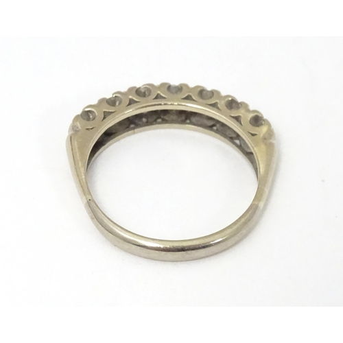 622 - An 18ct white gold half eternity ring set with seven diamonds in a linear setting. Ring size approx.... 