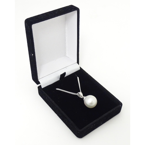 657 - A 9ct white gold pendant set South Sea cultured pearl & Sri Lankan white sapphire, on a silver chain... 