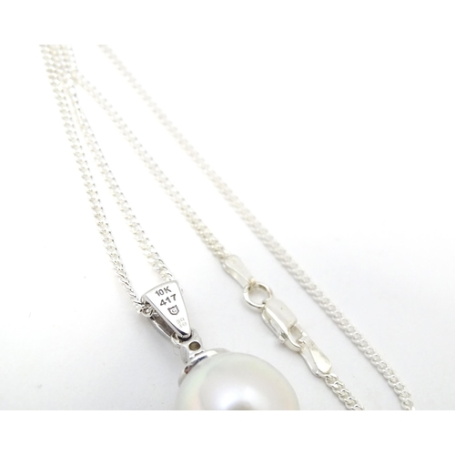 657 - A 9ct white gold pendant set South Sea cultured pearl & Sri Lankan white sapphire, on a silver chain... 