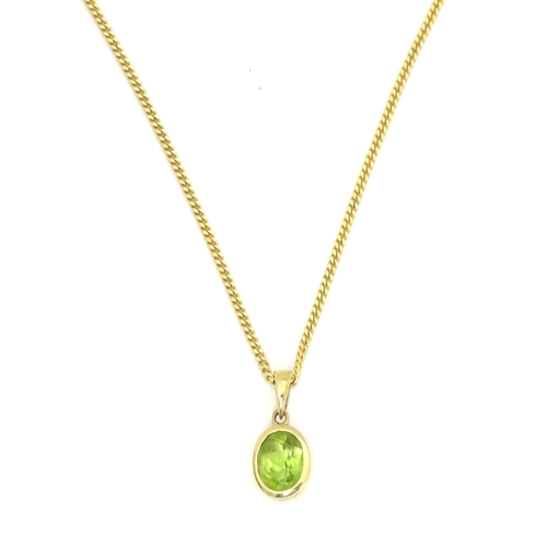 726 - A 9ct gold pendent set with peridot on a 9ct gold chain necklace. The chain 18