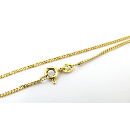 726 - A 9ct gold pendent set with peridot on a 9ct gold chain necklace. The chain 18