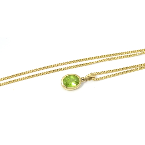 726 - A 9ct gold pendent set with peridot on a 9ct gold chain necklace. The chain 18