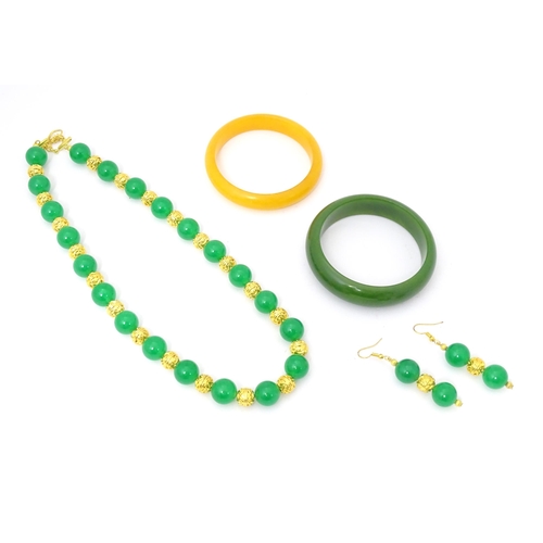 763 - Assorted jade jewellery to include bead necklace and earrings and two bangles.