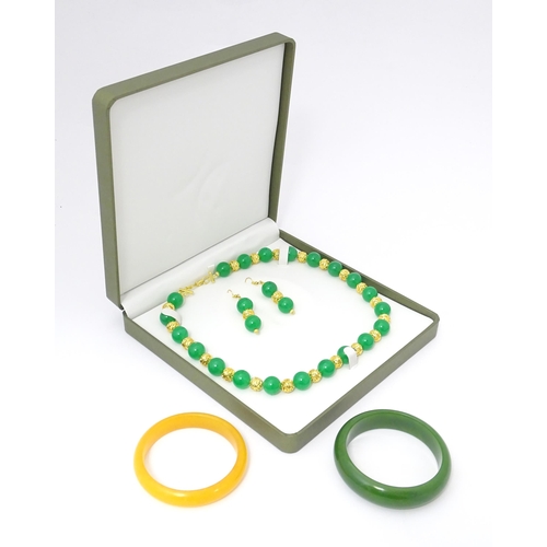 763 - Assorted jade jewellery to include bead necklace and earrings and two bangles.