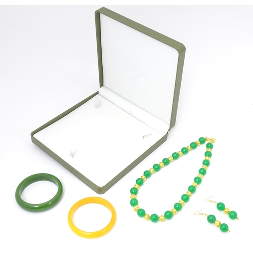 763 - Assorted jade jewellery to include bead necklace and earrings and two bangles.