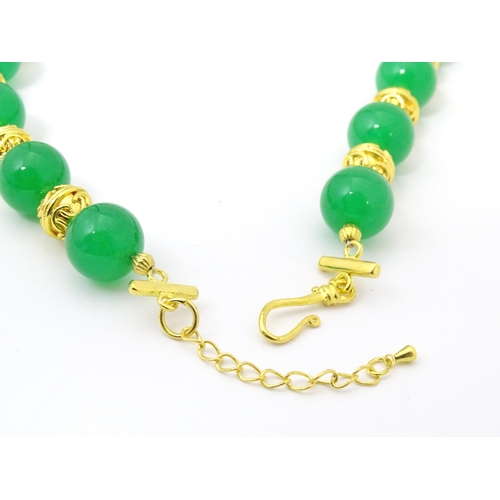 763 - Assorted jade jewellery to include bead necklace and earrings and two bangles.