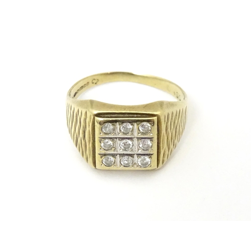 607A - A 9ct gold signet ring set with cubic zirconia. Ring size approx Q 1/2