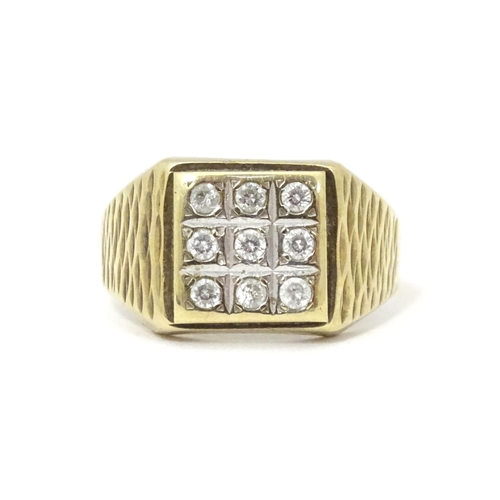 607A - A 9ct gold signet ring set with cubic zirconia. Ring size approx Q 1/2