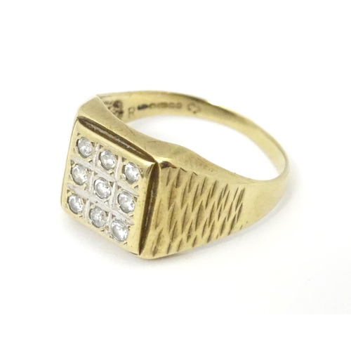 607A - A 9ct gold signet ring set with cubic zirconia. Ring size approx Q 1/2