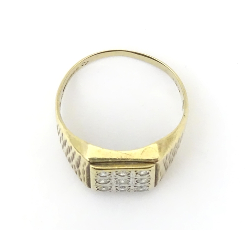 607A - A 9ct gold signet ring set with cubic zirconia. Ring size approx Q 1/2