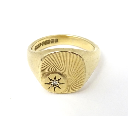 609A - A 9ct gold signet ring set with a diamond. Ring size approx Q.