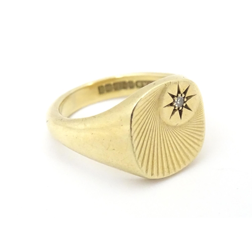 609A - A 9ct gold signet ring set with a diamond. Ring size approx Q.