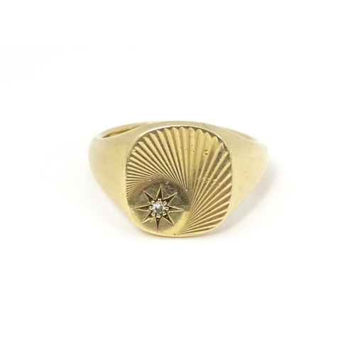 609A - A 9ct gold signet ring set with a diamond. Ring size approx Q.