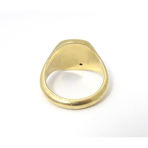 609A - A 9ct gold signet ring set with a diamond. Ring size approx Q.