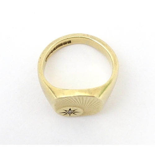 609A - A 9ct gold signet ring set with a diamond. Ring size approx Q.