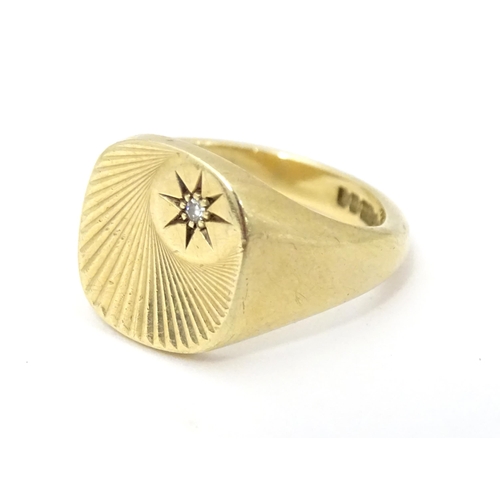 609A - A 9ct gold signet ring set with a diamond. Ring size approx Q.