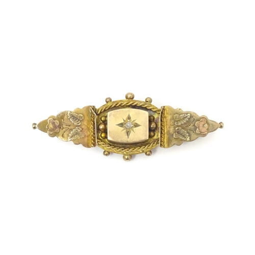 670A - A 9ct Victorian gold brooch set with central diamond. Hallmarked Birmingham 1899. 2