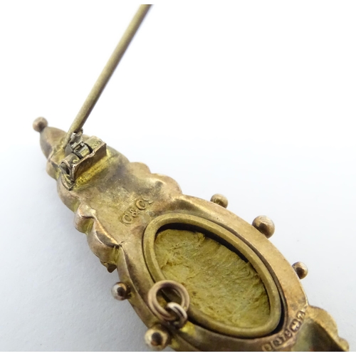 670A - A 9ct Victorian gold brooch set with central diamond. Hallmarked Birmingham 1899. 2