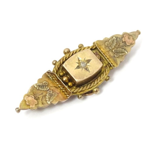 670A - A 9ct Victorian gold brooch set with central diamond. Hallmarked Birmingham 1899. 2