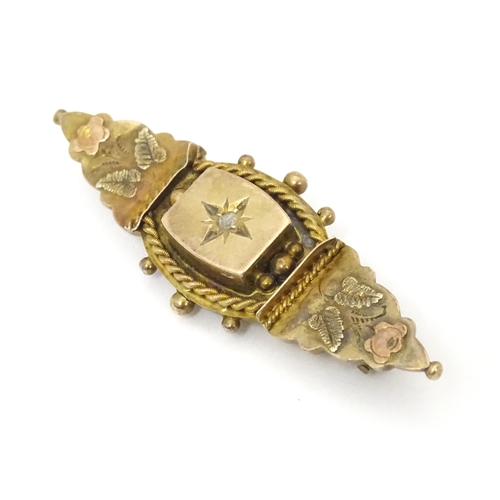 670A - A 9ct Victorian gold brooch set with central diamond. Hallmarked Birmingham 1899. 2