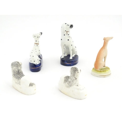 134 - Five 19thC Staffordshire pottery models of dogs, to include a pair of Poodles, two Dalmatians, and a... 