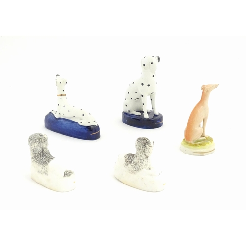 134 - Five 19thC Staffordshire pottery models of dogs, to include a pair of Poodles, two Dalmatians, and a... 