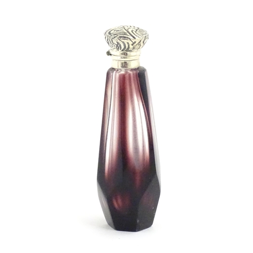 1147 - A scent / perfume bottle with white metal top and amethyst style facet cut glass body. Approx. 3 1/2... 