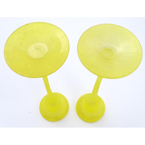 163 - A pair of retro yellow art glass candlesticks. Approx 10 1/2