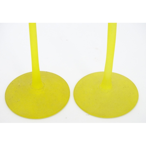 163 - A pair of retro yellow art glass candlesticks. Approx 10 1/2