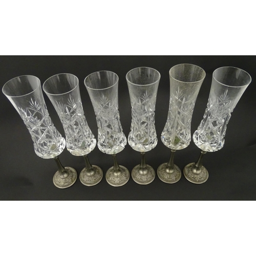 164 - A set of six Italian cut glass champagne flutes raised on  pewter stem and foot. Approx 11