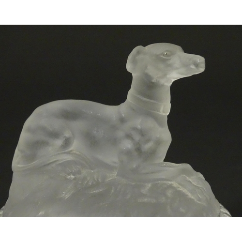 184 - A frosted glass model of a greyhound dog upon a lid formed base. Approx 2 1/2